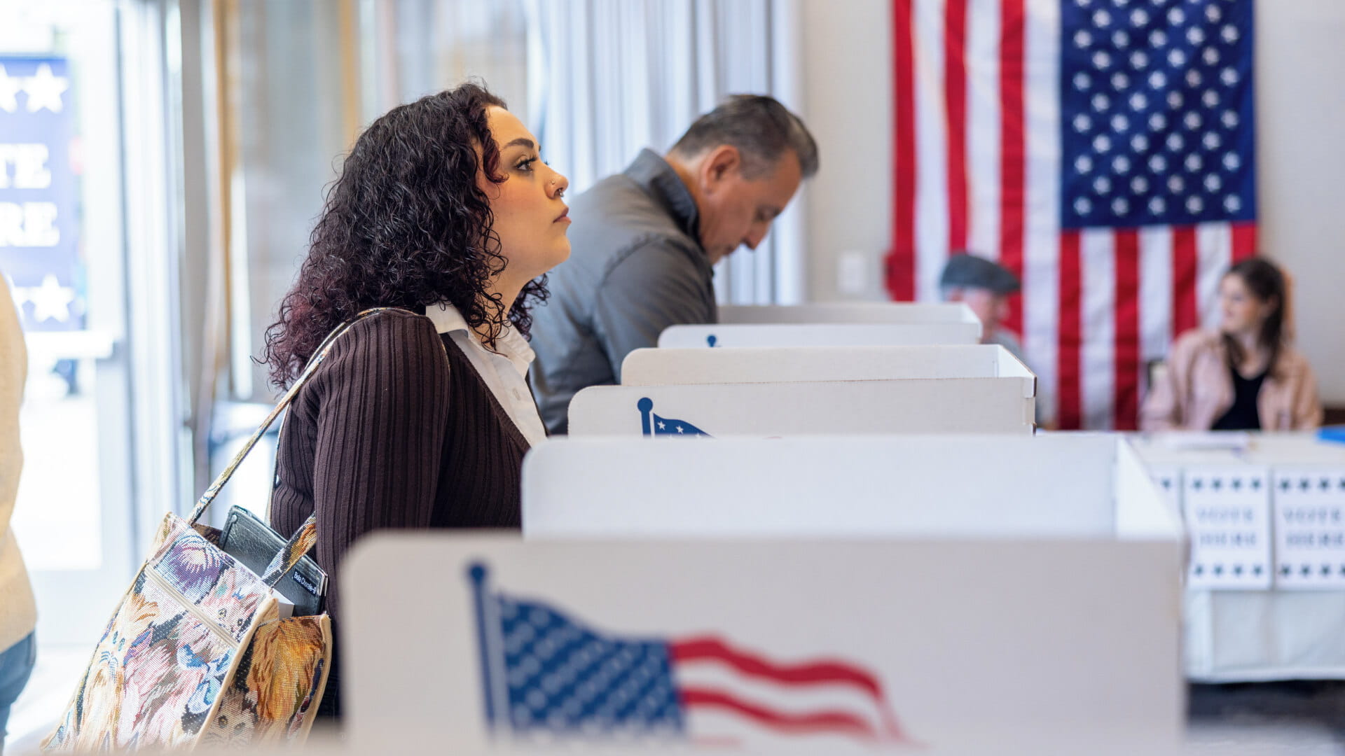Voters at polling stations during a U.S. election, representing the political and electoral landscape.